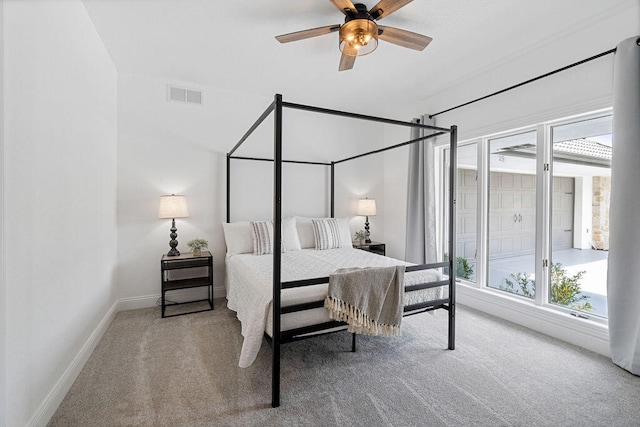 bedroom with ceiling fan and light carpet