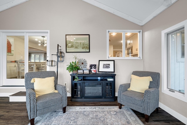 sitting room with lofted ceiling, hardwood / wood-style floors, and a fireplace