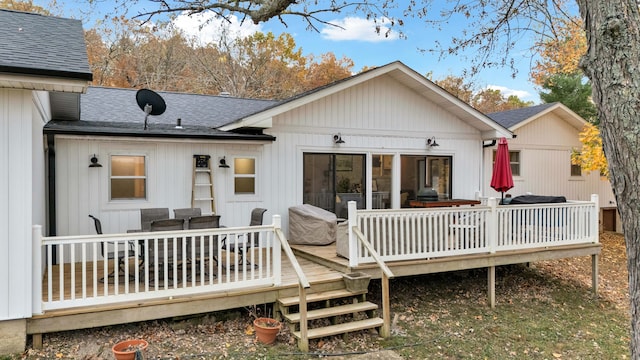 rear view of house featuring a wooden deck