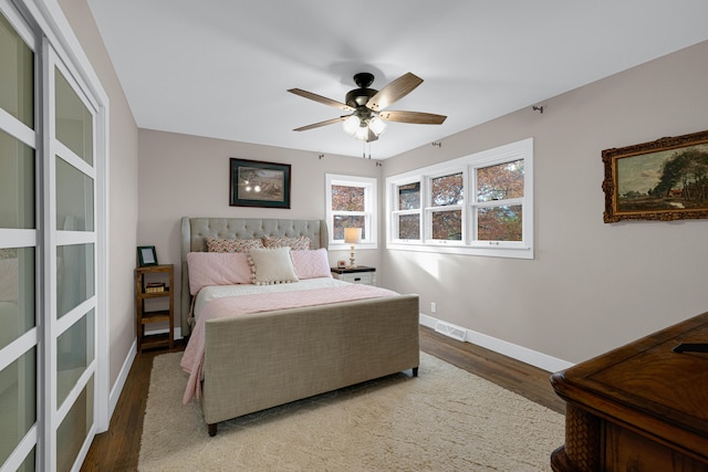 bedroom with hardwood / wood-style floors and ceiling fan