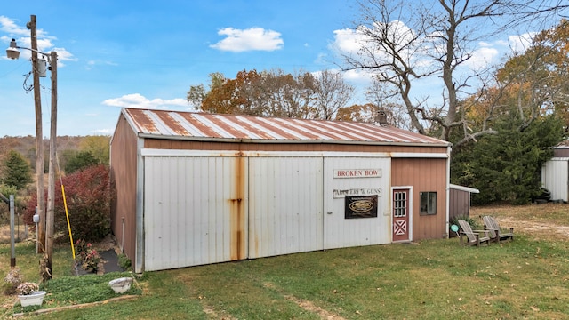 view of outbuilding with a yard