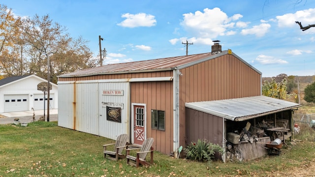 view of outdoor structure with a yard and a garage