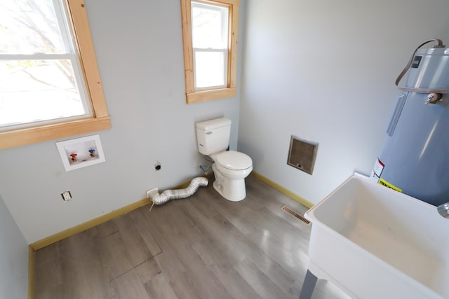 bathroom featuring toilet, hardwood / wood-style floors, sink, and plenty of natural light