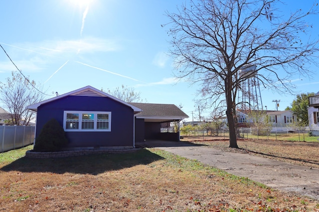 view of property exterior featuring a lawn and a carport