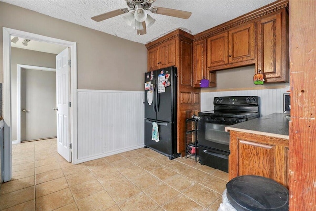 kitchen with ceiling fan, a textured ceiling, light tile patterned floors, and black appliances