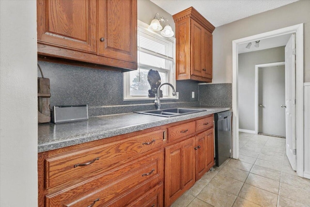 kitchen featuring black dishwasher, sink, tasteful backsplash, and light tile patterned floors