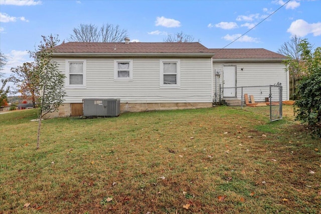 back of property with a yard and cooling unit