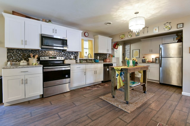 kitchen with white cabinetry, dark hardwood / wood-style floors, and stainless steel appliances