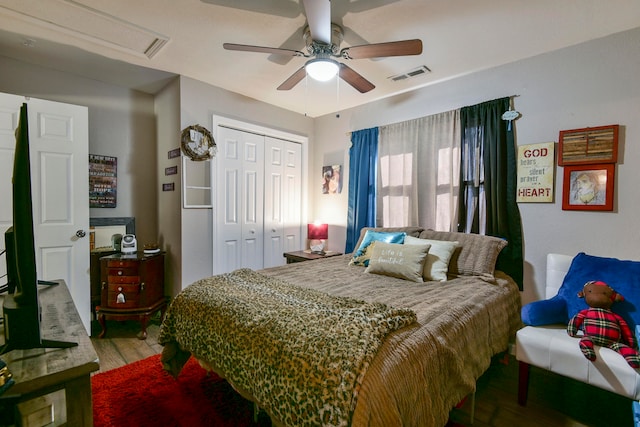 bedroom featuring ceiling fan, a closet, and wood-type flooring