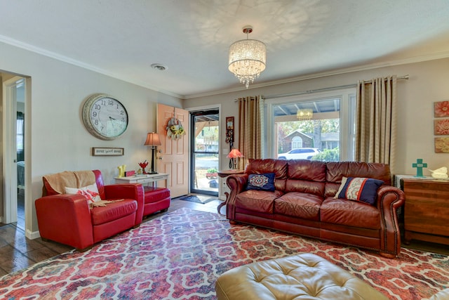 living room with an inviting chandelier and crown molding