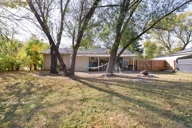 exterior space with a lawn and a fire pit