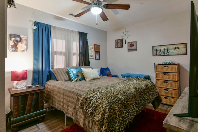 bedroom with dark wood-type flooring and ceiling fan