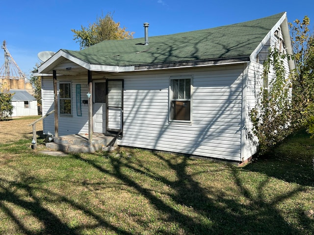 rear view of house with a yard