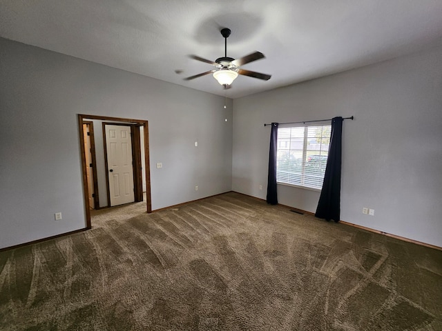 spare room featuring carpet and ceiling fan