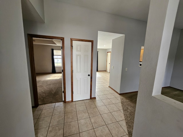 hallway featuring light colored carpet