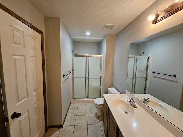 bathroom with walk in shower, tile patterned flooring, vanity, and toilet