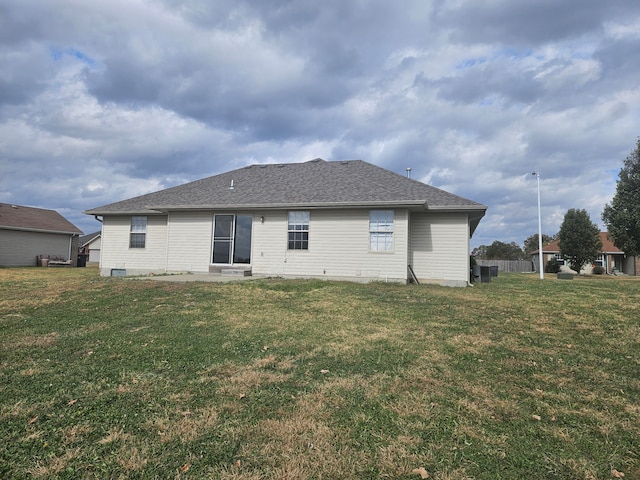 back of house with a lawn