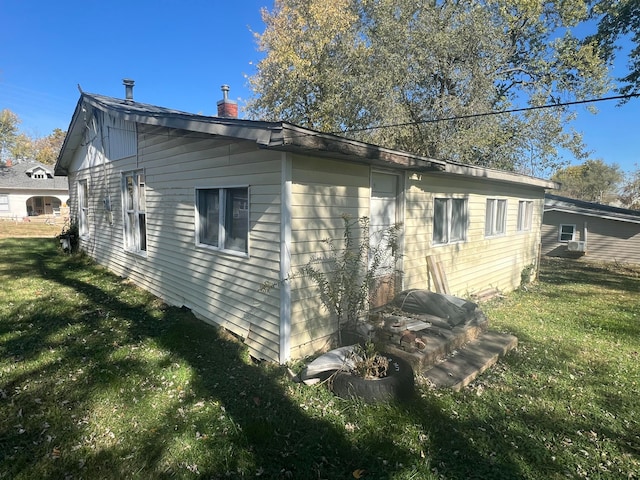 view of property exterior featuring a lawn