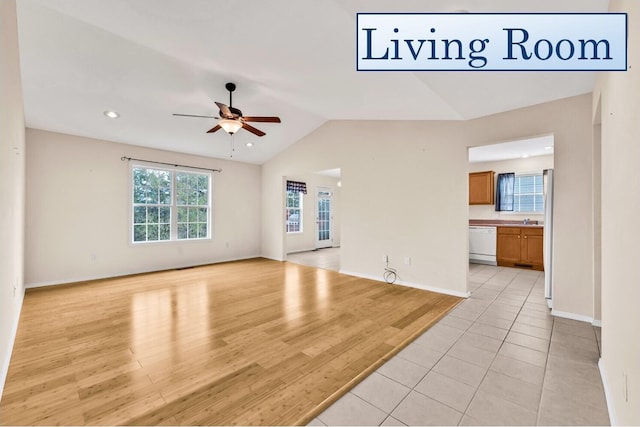 unfurnished living room featuring ceiling fan, light hardwood / wood-style flooring, and lofted ceiling