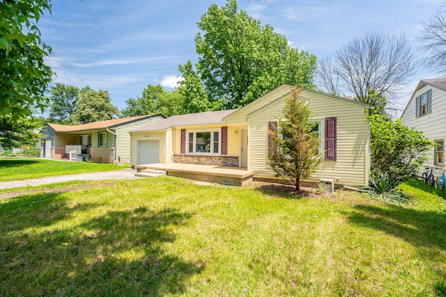 ranch-style house with a garage and a front lawn