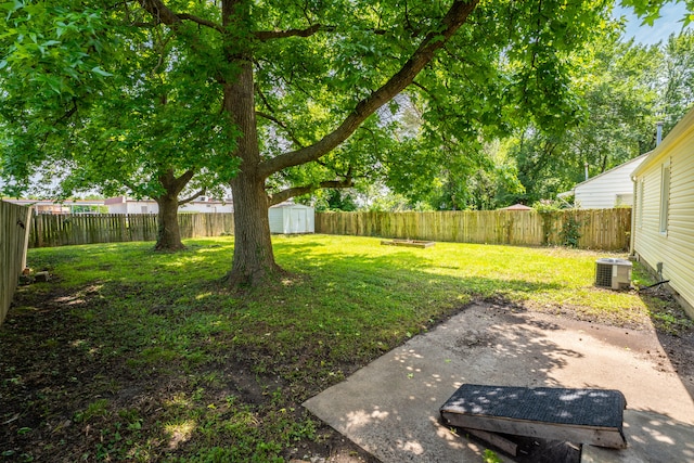 view of yard featuring central AC and a storage shed