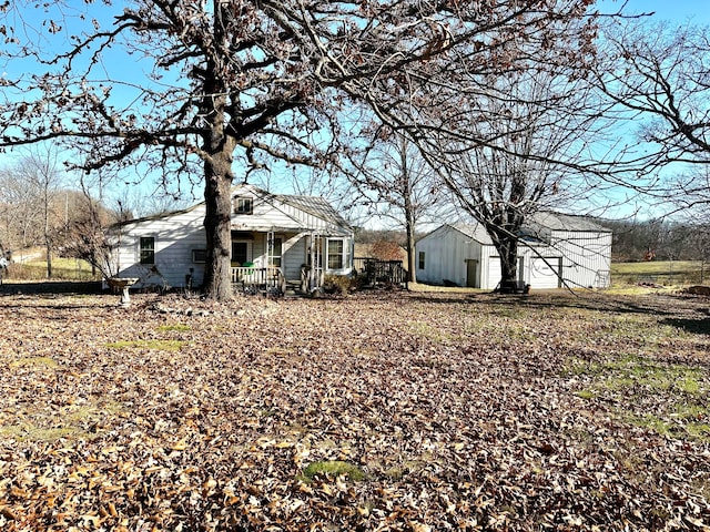 back of property featuring a porch