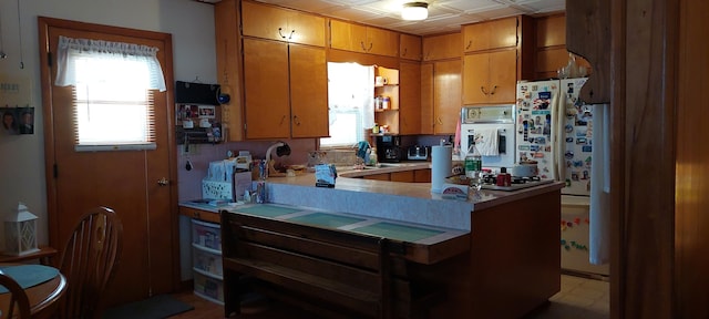 kitchen with white appliances and kitchen peninsula