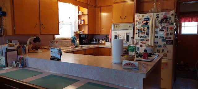 kitchen with stainless steel oven, white fridge, and sink