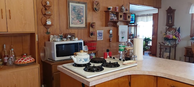 kitchen featuring wood walls and white appliances