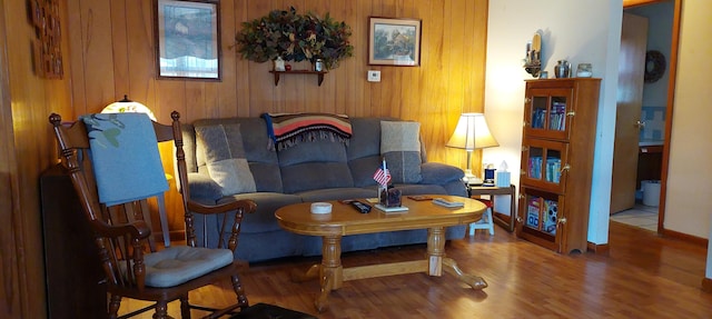 living room featuring wood walls and hardwood / wood-style flooring