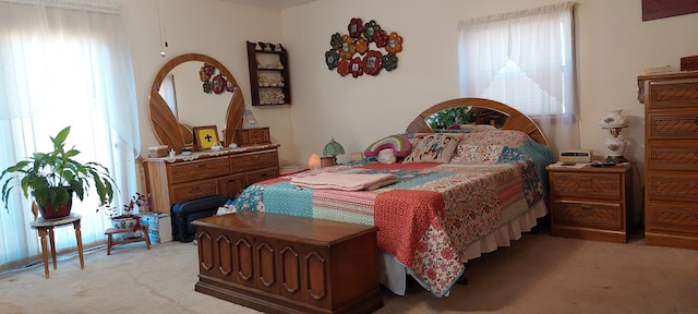 carpeted bedroom featuring multiple windows