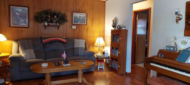 living room with wooden walls and wood-type flooring