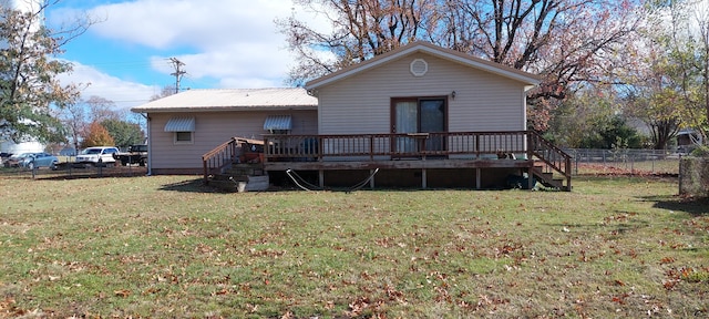 back of house featuring a yard and a deck