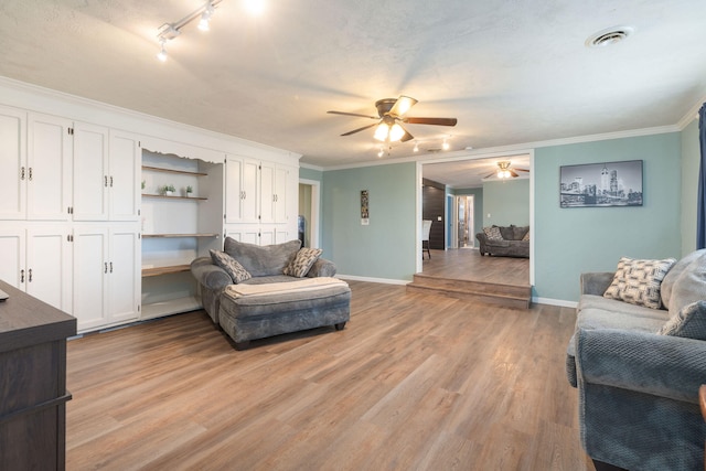 living room featuring ornamental molding, ceiling fan, and light hardwood / wood-style floors