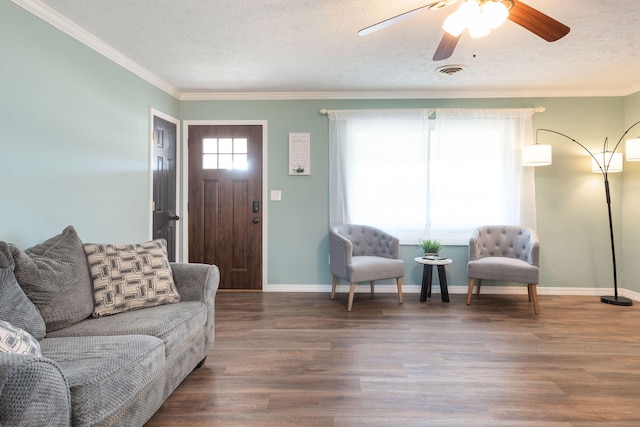 living room featuring ornamental molding, a textured ceiling, and dark hardwood / wood-style floors