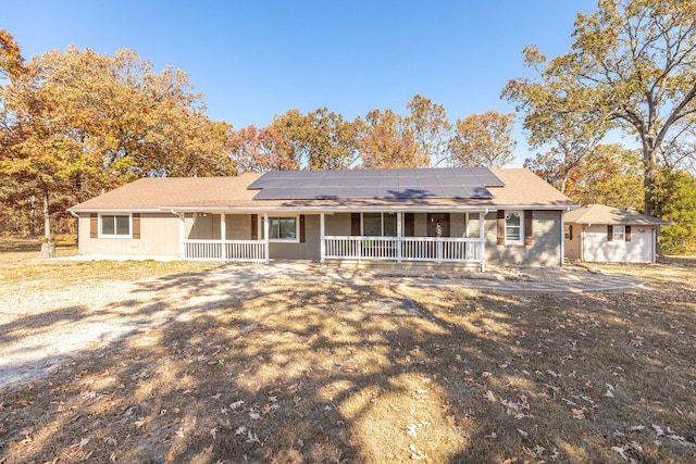 view of front of property with solar panels and covered porch