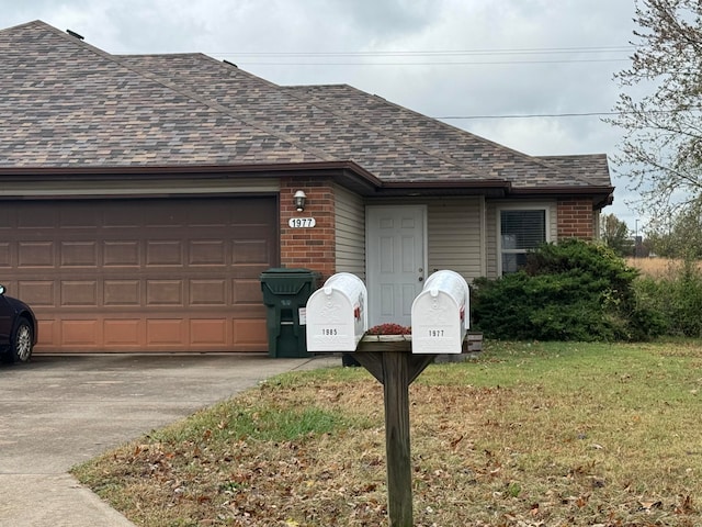 single story home with a garage and a front lawn