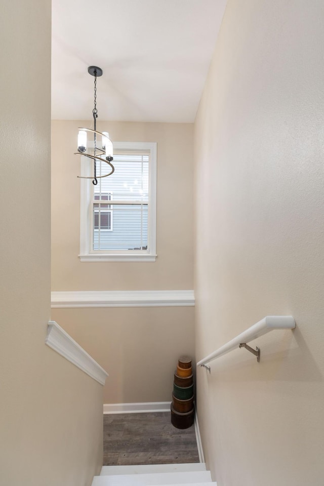 218 Windridge Rd, Branson, MO 65616 - staircase with a chandelier, wood finished floors, and baseboards