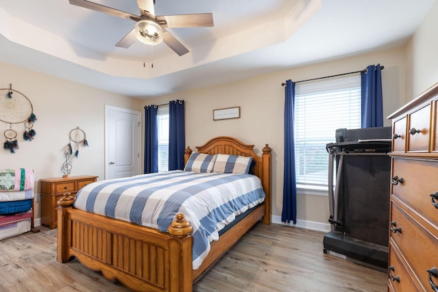 218 Windridge Rd, Branson, MO 65616 - bedroom with a tray ceiling, light wood finished floors, ceiling fan, and baseboards