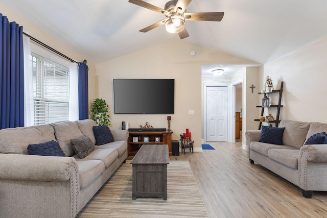 living room featuring light hardwood / wood-style floors, ceiling fan, and vaulted ceiling