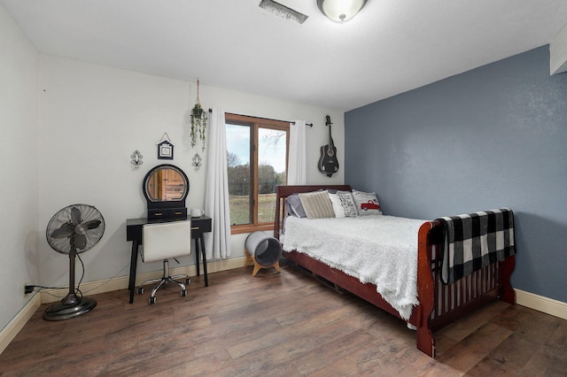 bedroom with dark wood-type flooring