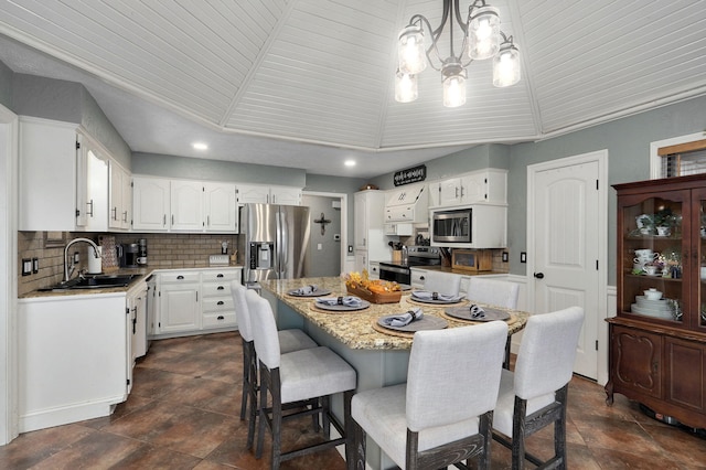 dining space with sink and a chandelier