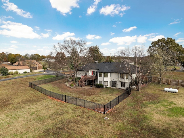 exterior space with a wooden deck and a lawn