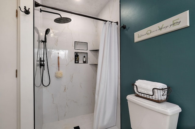 bathroom featuring toilet and a shower with shower curtain