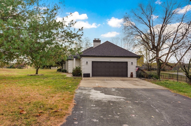 view of front of house featuring a garage and a front lawn