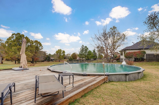 view of swimming pool featuring a yard and a wooden deck