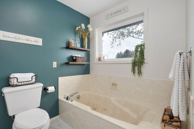 bathroom featuring a tub and toilet