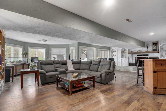 living room with hardwood / wood-style flooring and a textured ceiling