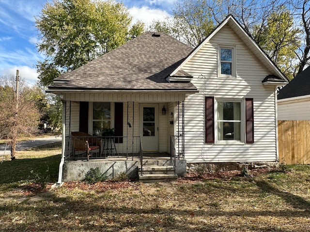 bungalow-style house featuring a porch and a front lawn