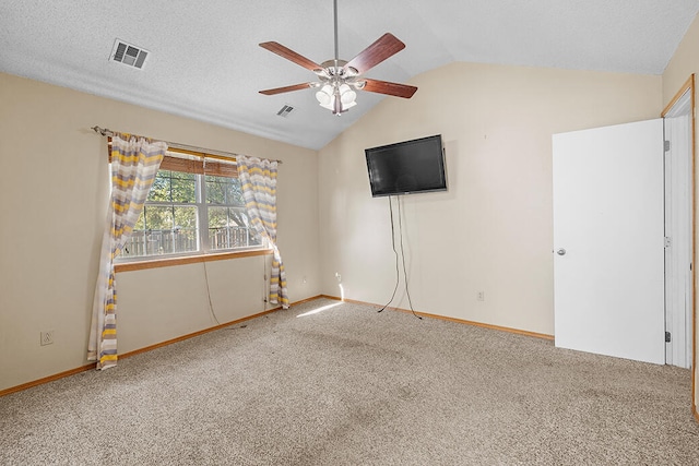 carpeted empty room with ceiling fan, a textured ceiling, and lofted ceiling